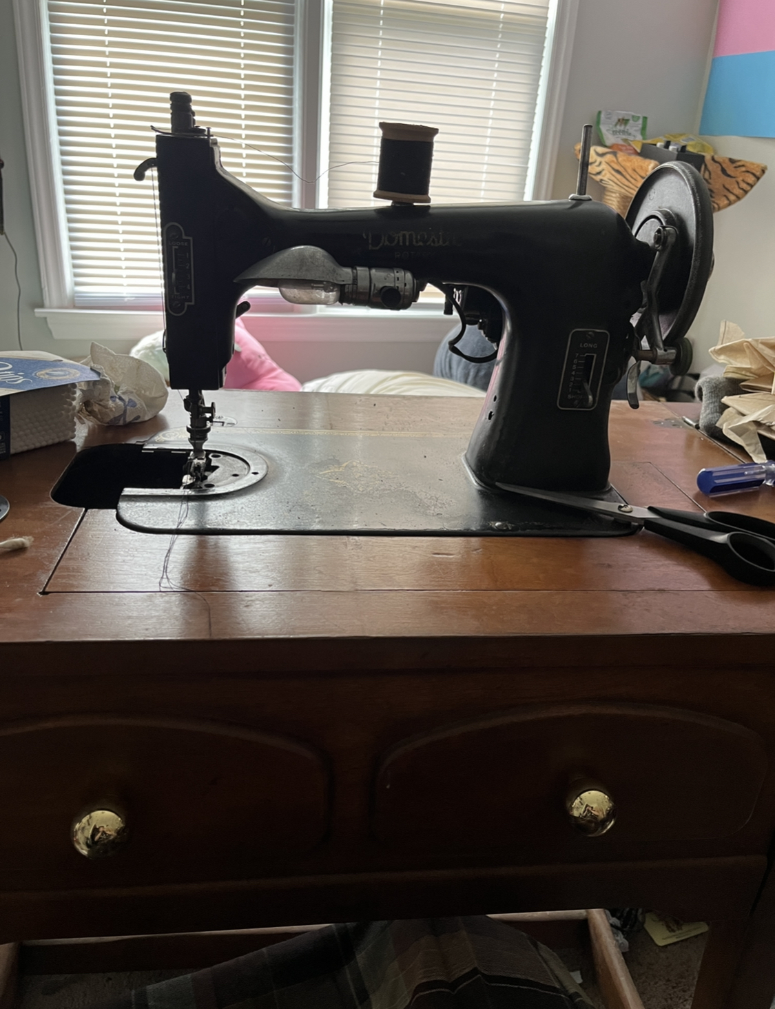 a black vintage sewing machine that says 'domestic rotary' on it in golden letters